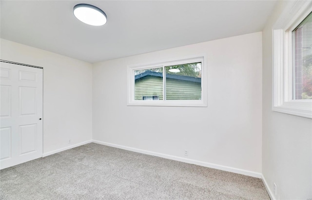 empty room featuring light colored carpet