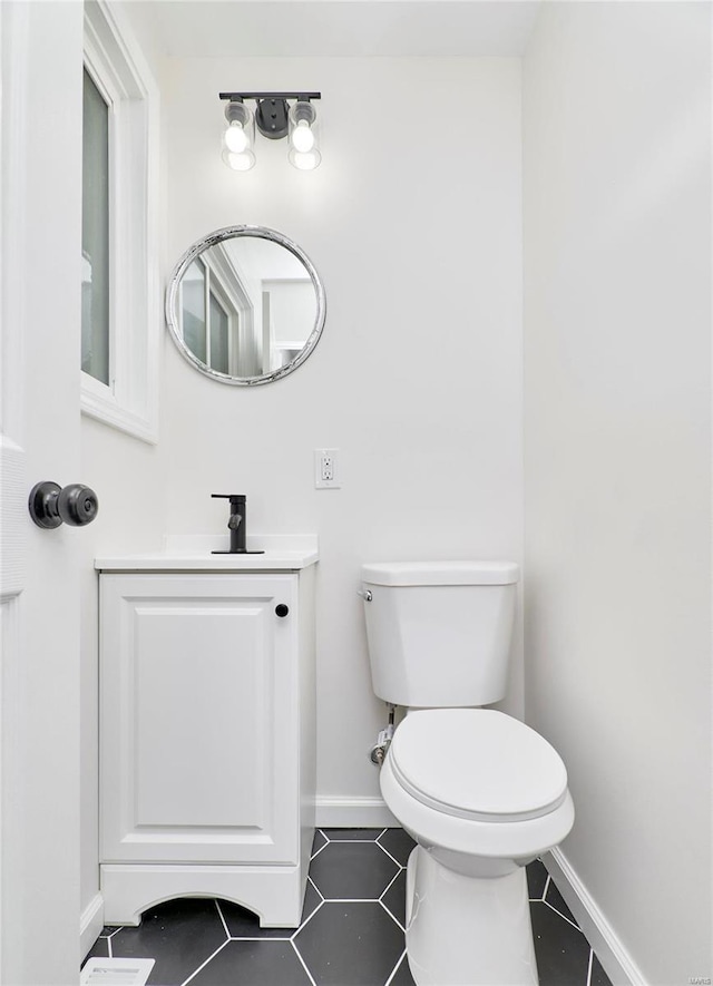 bathroom with vanity, tile patterned floors, and toilet