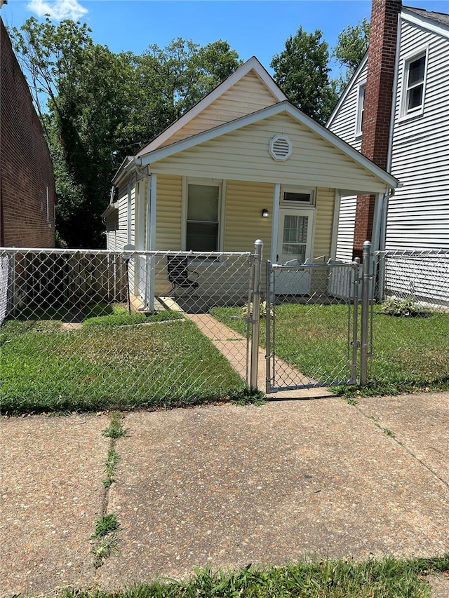 bungalow-style home with a front lawn and a porch