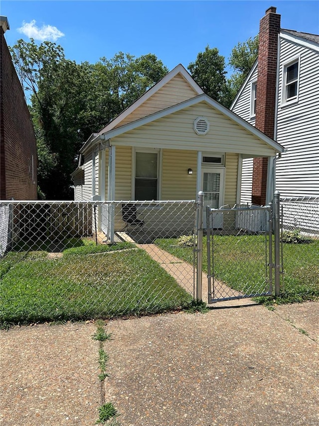 view of front of house featuring covered porch and a front lawn