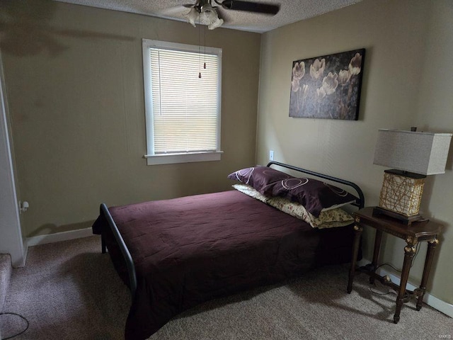 bedroom featuring ceiling fan, carpet flooring, and a textured ceiling