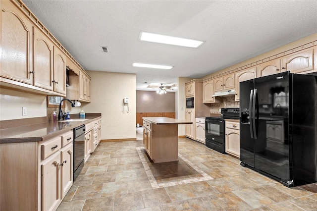 kitchen with a textured ceiling, black appliances, sink, and a center island