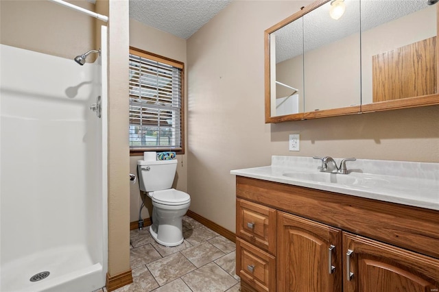 bathroom with tile patterned floors, walk in shower, vanity, a textured ceiling, and toilet