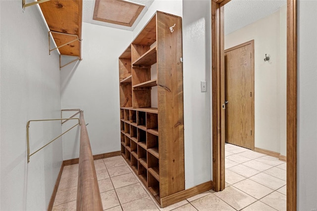 spacious closet with light tile patterned floors