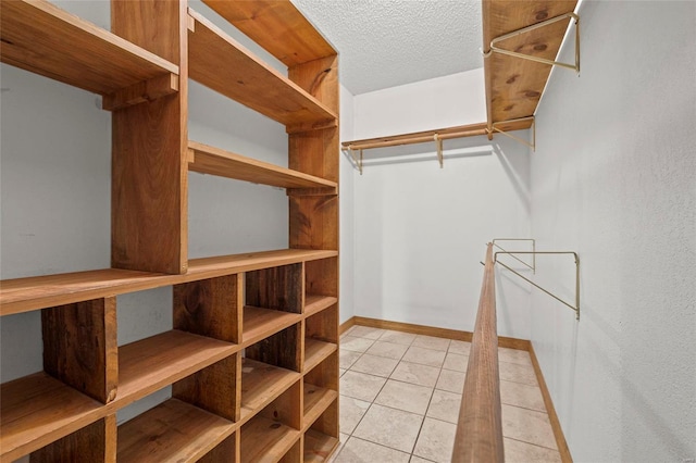 spacious closet with light tile patterned floors