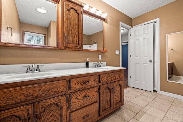 bathroom featuring vanity, a textured ceiling, and tile patterned floors