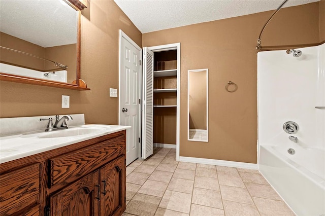 bathroom with vanity, a textured ceiling, tile patterned floors, and shower / bath combination