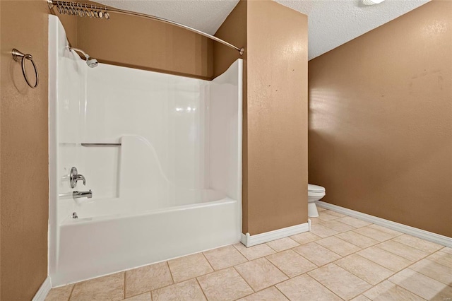 bathroom with toilet, bathtub / shower combination, a textured ceiling, and tile patterned floors