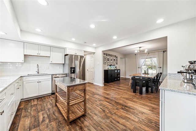 kitchen with white cabinets, sink, dark wood-type flooring, and appliances with stainless steel finishes