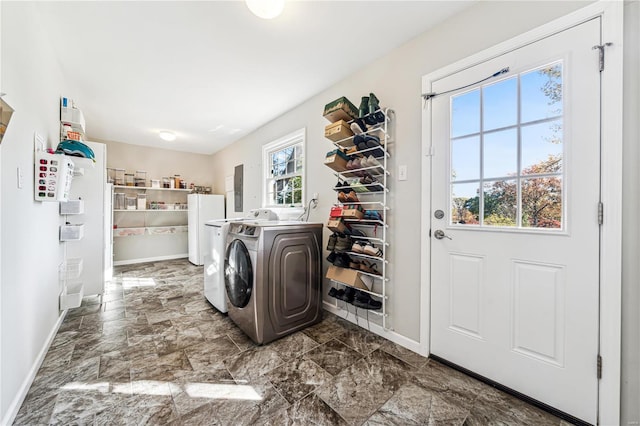 clothes washing area with independent washer and dryer