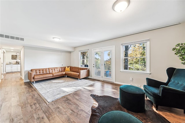 living room featuring wood-type flooring and french doors