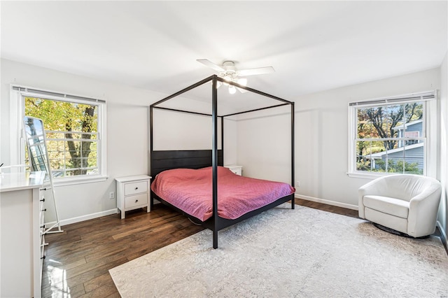 bedroom with dark hardwood / wood-style floors and ceiling fan