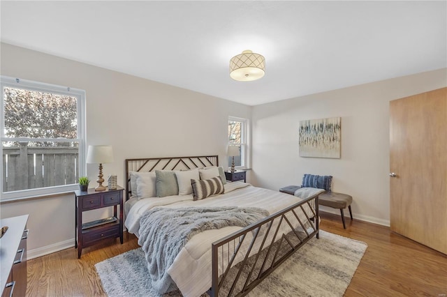 bedroom with light wood-style floors and baseboards