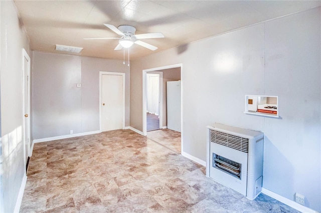 unfurnished living room with heating unit and ceiling fan