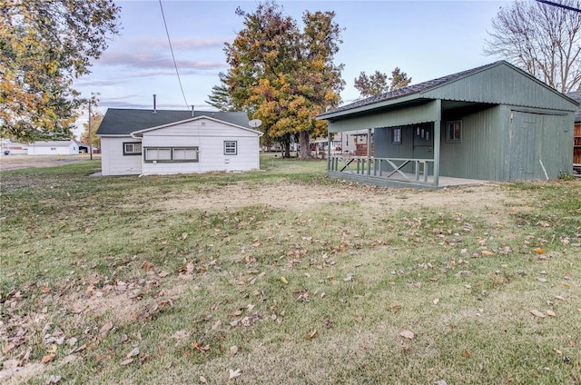 rear view of house featuring a yard