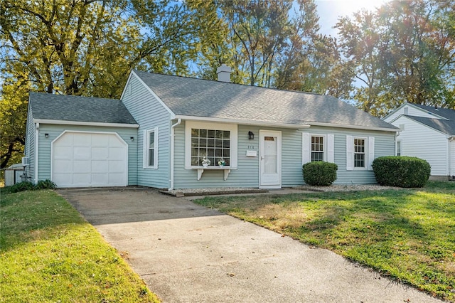 view of front of home with a front yard and a garage