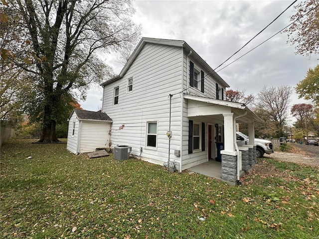 view of home's exterior featuring a yard, a storage unit, and central air condition unit