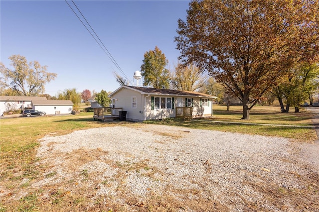 view of front of property with a front lawn and a deck