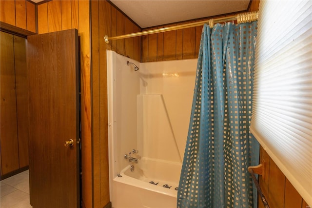 bathroom featuring shower / tub combo with curtain, wood walls, a textured ceiling, and tile patterned floors