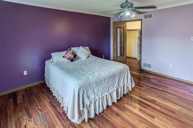 bedroom featuring ceiling fan, dark hardwood / wood-style floors, and ornamental molding