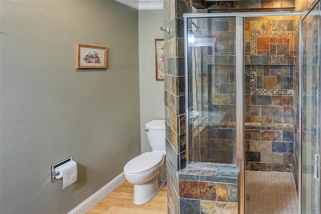 bathroom featuring hardwood / wood-style floors, walk in shower, and toilet