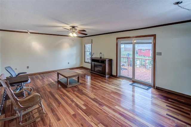 living room with a textured ceiling, hardwood / wood-style flooring, and ceiling fan