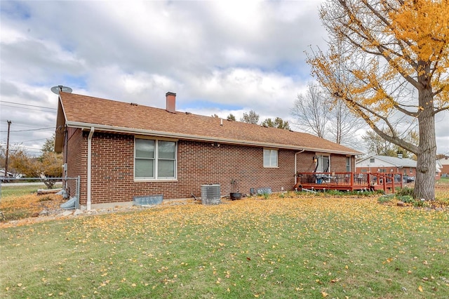 back of property featuring central AC, a lawn, and a deck