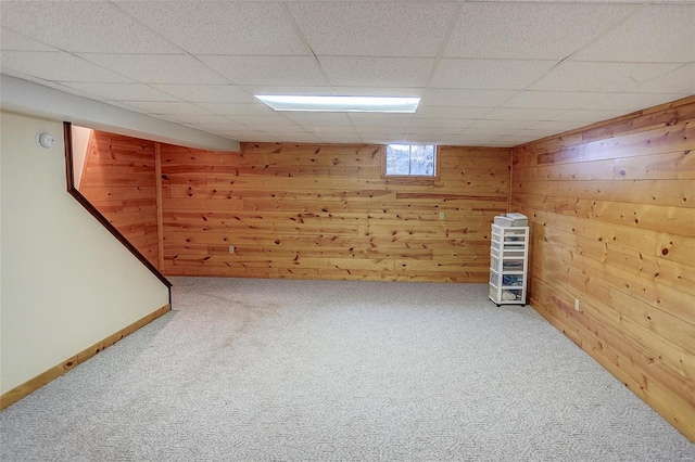 basement with wooden walls and carpet floors