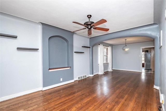 unfurnished room with dark hardwood / wood-style flooring and ceiling fan