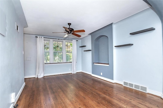 spare room with dark hardwood / wood-style flooring and ceiling fan