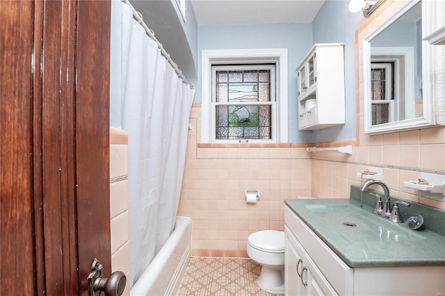 full bathroom with toilet, vanity, shower / bath combo with shower curtain, and tile walls