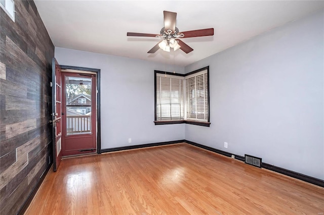 spare room with hardwood / wood-style floors and ceiling fan