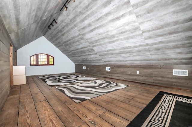 bonus room with hardwood / wood-style flooring and vaulted ceiling