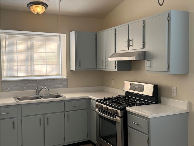 kitchen with gray cabinets, gas range, and sink