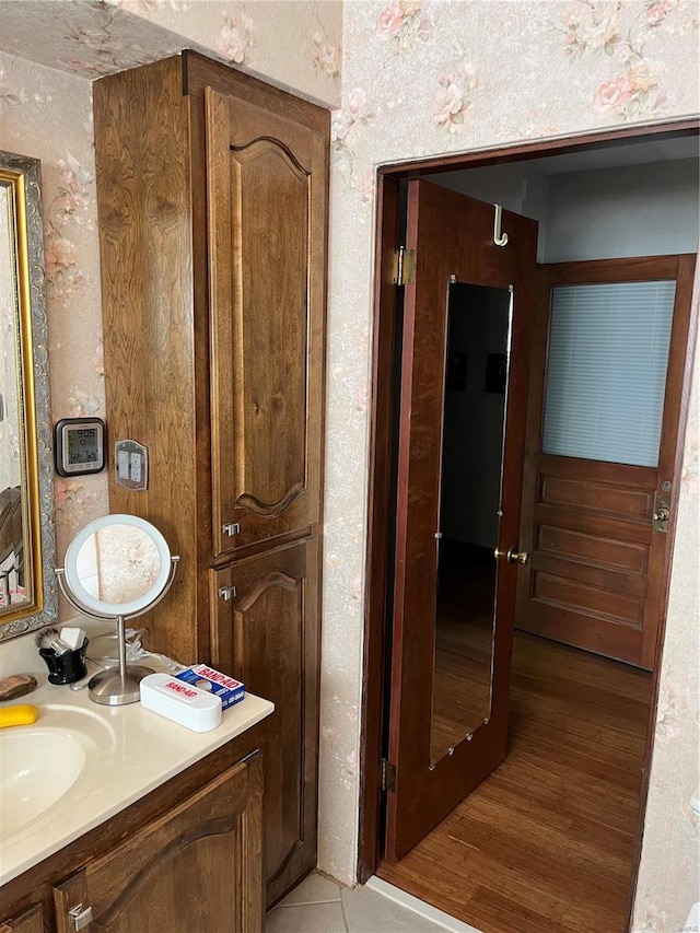 bathroom with vanity and wood-type flooring