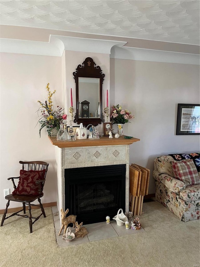 living room with carpet, a textured ceiling, and a tile fireplace