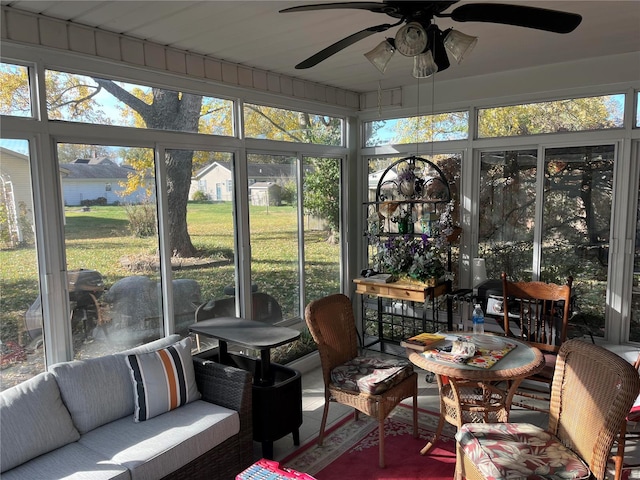 sunroom / solarium featuring ceiling fan