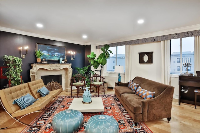 living room featuring light wood-type flooring, a wealth of natural light, crown molding, and a premium fireplace