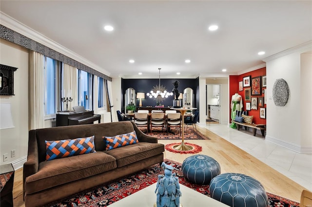 living room with light hardwood / wood-style floors, a notable chandelier, and crown molding