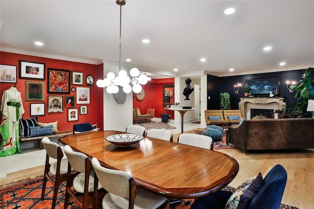 dining area featuring light hardwood / wood-style flooring, a chandelier, and crown molding