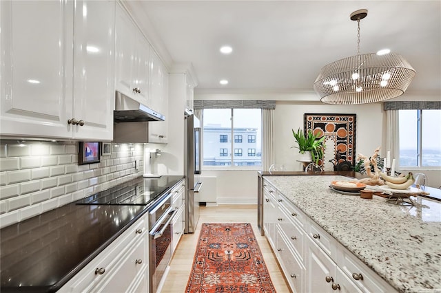 kitchen featuring white cabinetry, stainless steel appliances, a healthy amount of sunlight, and light hardwood / wood-style flooring