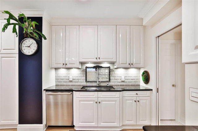 kitchen featuring white cabinets, decorative backsplash, and dishwasher