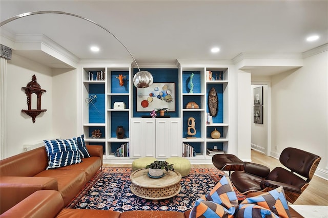 living room with hardwood / wood-style floors and ornamental molding