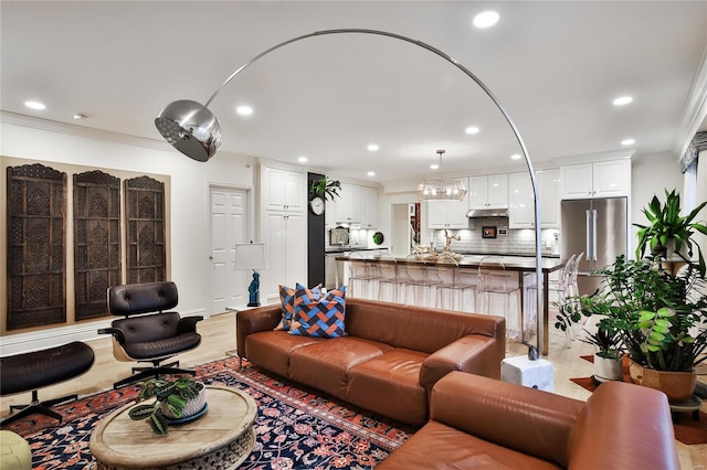 living room with light hardwood / wood-style flooring and crown molding