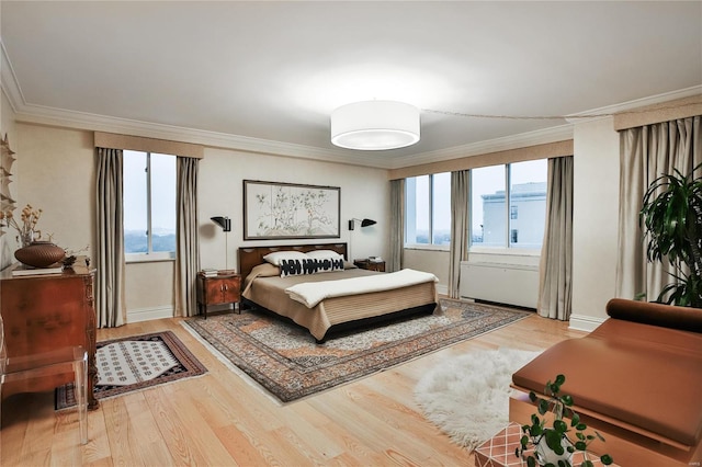 bedroom with ornamental molding and hardwood / wood-style flooring