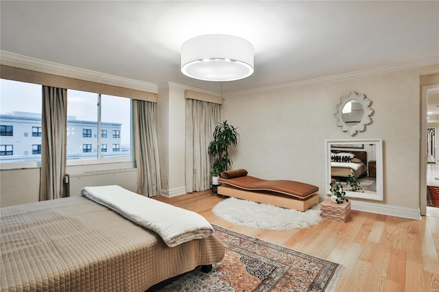 bedroom featuring light hardwood / wood-style floors and crown molding