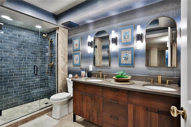 bathroom with vanity, tile patterned floors, toilet, and a shower with door