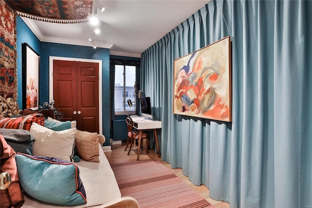 sitting room with light hardwood / wood-style floors, rail lighting, and crown molding