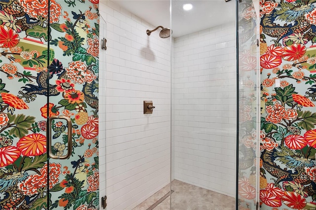 bathroom featuring a shower with shower door