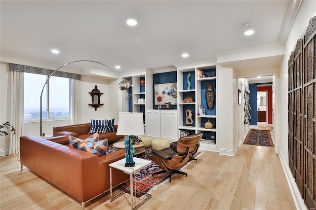 living room with light hardwood / wood-style flooring and ornamental molding